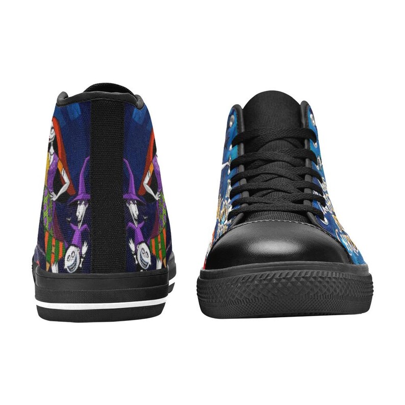 May include: High-top sneakers featuring a dark blue background with a colorful graphic print of animated characters including a tall figure in a striped dress and smaller figures in purple hats. The shoes have black laces, black toe caps, and white soles.