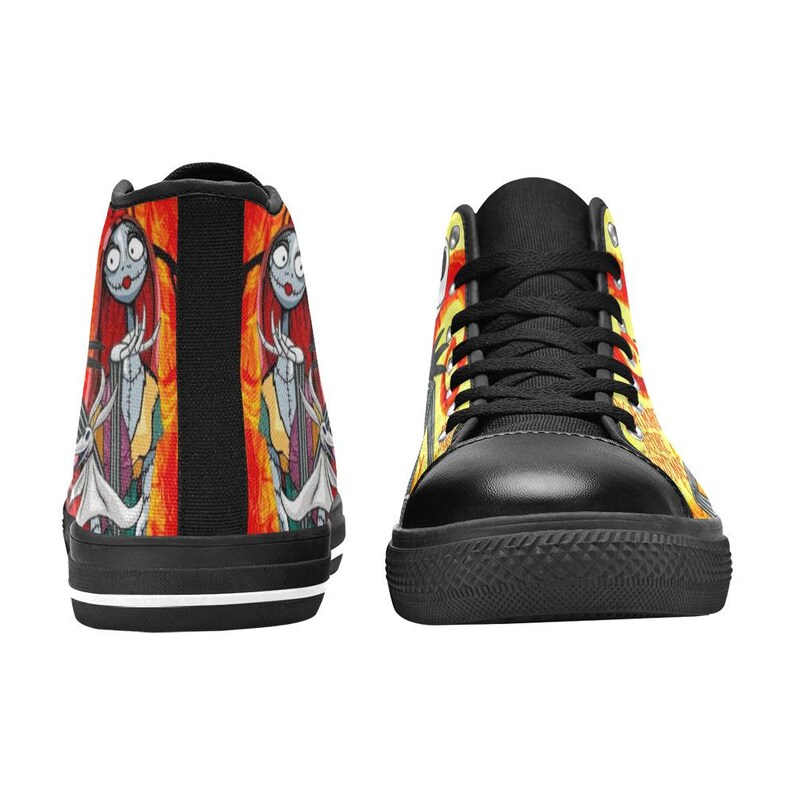 May include: High-top sneakers featuring a black toe cap, black laces, and a vibrant graphic print of a female character with stitched skin and a white ghost dog against a fiery orange and yellow background with black vertical stripes.