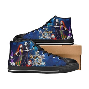 May include: High-top sneakers featuring a blue background with characters from The Nightmare Before Christmas, including Jack Skellington and Sally. The shoes have black laces, black toe caps, and black soles with white stripes, displaying the movie title.