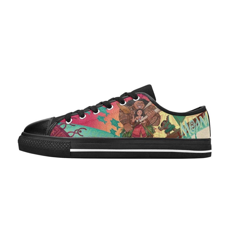 May include: Low-top canvas sneakers with a black toe cap and black laces. The side of the shoe features a colorful graphic of characters from the animated film "Moana" with the word "Moana" in green.