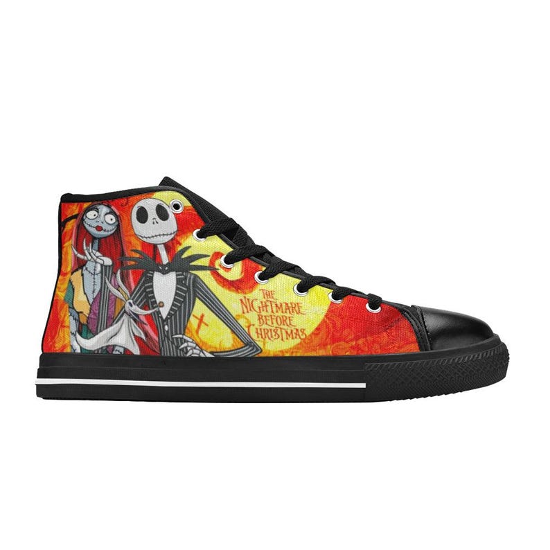 May include: A high-top sneaker featuring a vibrant yellow and red background with a graphic print of Jack Skellington, Sally, and Zero from The Nightmare Before Christmas. The shoe has black laces, a black toe cap, and a black sole with a white stripe.