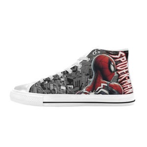 May include: High-top canvas sneakers featuring a Spider-Man design. The shoe has a white sole and laces, with a black and white cityscape pattern on the side. The Spider-Man graphic is red and black, with the word "SPIDER-MAN" in red.