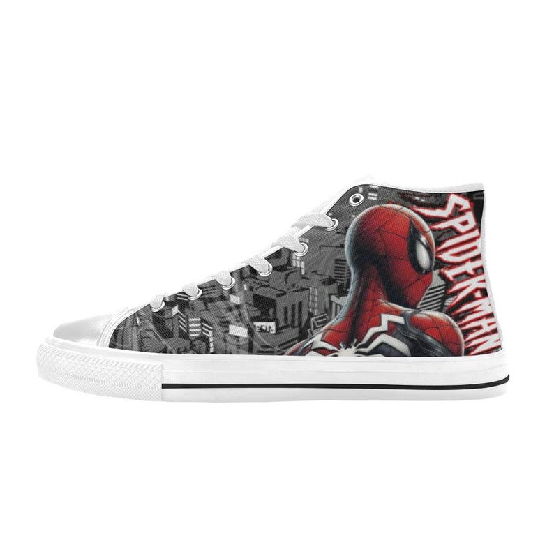 May include: High-top canvas sneakers featuring a Spider-Man design. The shoe has a white sole and laces, with a black and white cityscape pattern on the side. The Spider-Man graphic is red and black, with the word "SPIDER-MAN" in red.