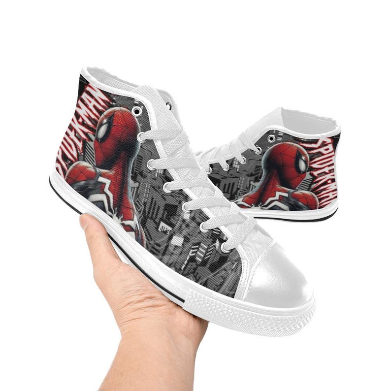 May include: White high-top sneakers featuring a Spider-Man design. The sneakers have a white toe cap, white laces, and a Spider-Man graphic on the side. The words "SPIDER-MAN" are printed on the side of the shoe.