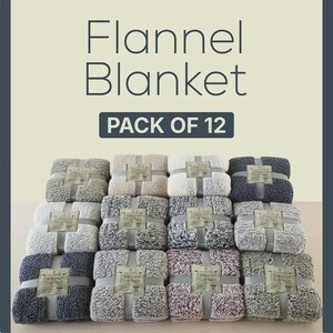 Peut inclure: Un lot de 12 couvertures en flanelle pliées dans des tons neutres comme le beige, le gris, le charbon et le mauve. Chaque couverture est maintenue par une bande en papier marquée Flannel Blanket. Le texte Flannel Blanket PACK OF 12 est en haut.