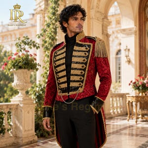 May include: A red and black military-style tailcoat featuring gold embroidery, black lapels, gold fringe epaulets, and a decorative chain across the front. The jacket is worn over a black shirt and black trousers, with the Duke's Regiment logo visible.
