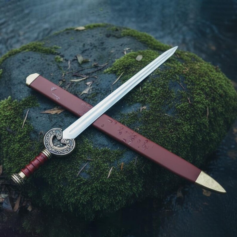 May include: A decorative sword with a silver blade and a red and gold handle. The sword rests on a red sheath with gold accents. The sword's hilt features an ornate, circular design.