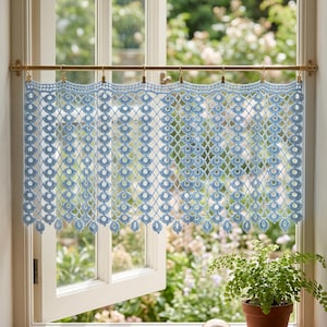 May include: A light blue, crocheted window curtain with a geometric pattern hangs from a brass rod. The curtain is made of a delicate, open weave, allowing light to filter through. A potted fern sits on the windowsill.