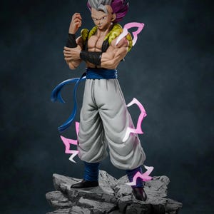 May include: A detailed figurine of a character with spiky gray and purple hair, wearing a white and blue outfit. The figure is posed on a rocky base, with pink energy effects surrounding it. The character has a muscular build and black wristbands.