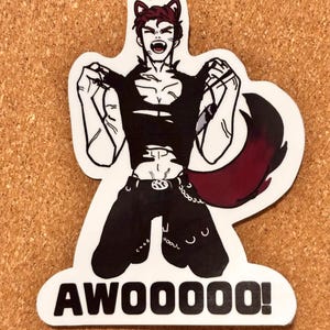 May include: A die-cut sticker featuring a cartoon character with dark hair, cat-like ears, and a large bushy tail. The character wears a torn black top and dark trousers with a chain, and is shown howling with the text AWOOOOO! printed in bold black letters.