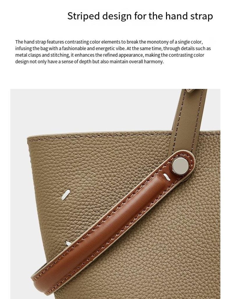 May include: A close-up of a handbag. The bag has an olive-green textured body and a brown leather handle. The handle is attached with a silver metal clasp. The text "Striped design for the hand strap" is at the top.