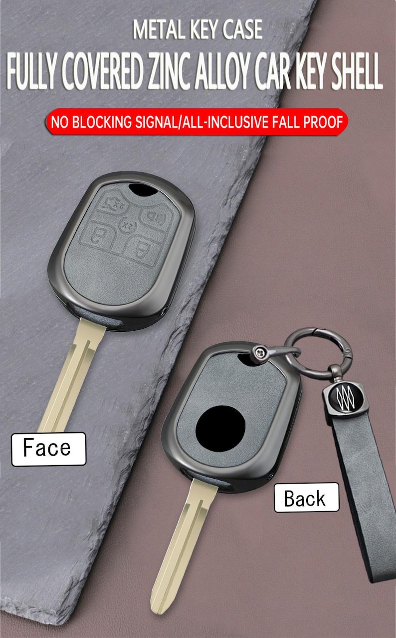 May include: Two car key shells made of zinc alloy. The face of the key shell has buttons, while the back has a circular design. The key shells are dark gray and have a key ring and a black leather strap. The text on the image says "METAL KEY CASE".