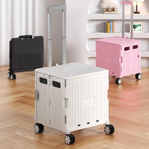 May include: Three folding utility carts in black, white, and pink. Each cart has a telescoping handle and rolling wheels. The white cart is in the foreground, with the black cart on the left and the pink cart on the right.