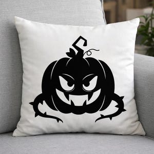 May include: White square throw pillow featuring a black Halloween pumpkin design. The pumpkin has a menacing face with sharp teeth, and is surrounded by thorny vines. The pillow is on a gray sofa.