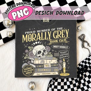 May include: A charcoal gray t-shirt featuring a graphic with a skull resting on a stack of books, surrounded by roses and a lit candle. The text reads: PROUD MEMBER OF THE MORALLY GREY BOOK CLUB, MEET WEEKLY, TRIGGER WARNINGS WELCOME, and ENEMIES TO LOVERS MONTH.