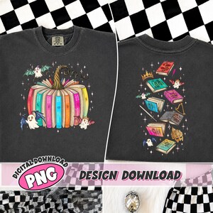 May include: A charcoal gray sweatshirt featuring a graphic of a pumpkin made from colorful books with small ghosts and stars. The back design displays a collection of various books, a crown, a sword, and ghosts scattered with sparkling stars.