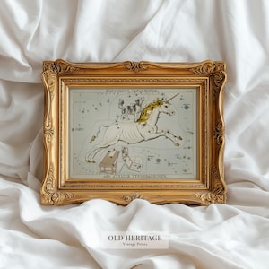 May include: A framed vintage print featuring a white unicorn with a golden mane and horn, set against a celestial map. The print is in a gold ornate frame. The text "OLD HERITAGE Vintage Prints" is at the bottom.