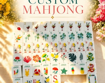 May include: A set of white rectangular Mahjong tiles featuring colorful illustrations of cocktails, palm trees, beach huts, flowers, sea life, and fruit. The tiles include numbered sets, Joker tiles, and lettered tiles, all arranged in a grid pattern.