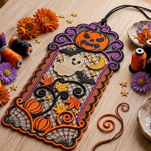 May include: A rectangular Halloween-themed embroidered wall hanging featuring a jack-o'-lantern, a ghost, bats, a crescent moon, and pumpkins. The design includes black, orange, and purple thread work with a lattice pattern, finished with a black cord.
