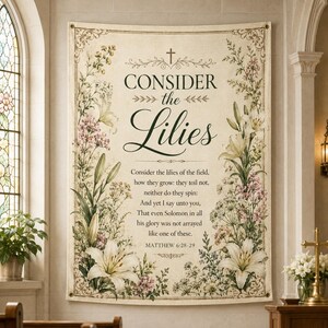 May include: A beige tapestry with floral and botanical illustrations, featuring the text "CONSIDER the Lilies" and a Bible verse. The design includes lilies and other flowers, with a cross at the top. The tapestry is framed with a decorative border.