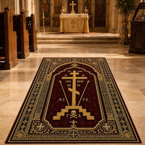 May include: A rectangular rug featuring a deep burgundy background with intricate gold and dark blue borders. The center displays a large gold Orthodox cross, a skull and crossbones, and Cyrillic text, all framed by ornate decorative patterns.