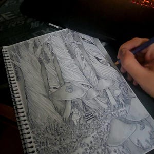 May include: A white ceramic mug with a black handle and the text "But First, Coffee" in a bold, black font. The mug is set against a blurred background, suggesting a cozy setting.