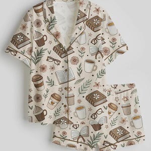 May include: A white ceramic mug with a black handle and the text "But First, Coffee" in a black, bold font. The mug is sitting on a wooden surface. The mug is approximately 4 inches tall.