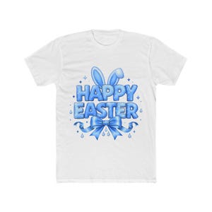May include: White t-shirt with a blue "Happy Easter" graphic. The design includes bunny ears, a bow, and water droplet accents. The text is in a bubble letter style.