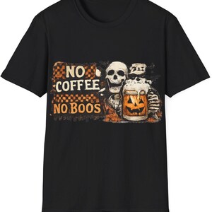 May include: A black short-sleeved t-shirt featuring a graphic print of a skeleton holding a jack-o'-lantern mug. The text reads NO COFFEE NO BOOS in a distressed orange and black checkered background style, with a white foam top on the mug.