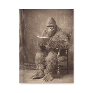May include: Sepia-toned image of a gorilla in a furry costume seated in an ornate chair, engrossed in reading a book. The gorilla is the central focus, with the book open in its hands. The background is a simple, textured backdrop.