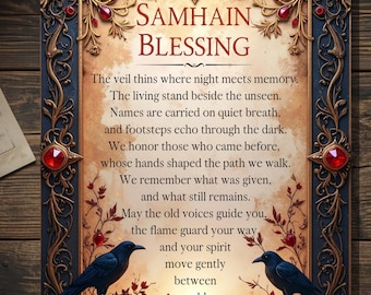 May include: A framed Samhain Blessing print. The artwork features ornate gold and blue detailing with red jewel accents. Two black ravens perch on floral branches, and the text of the blessing is centered within the frame.