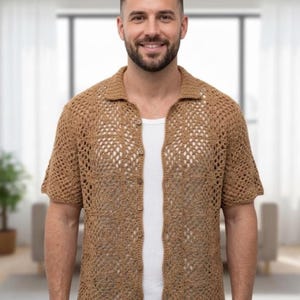 May include: A short-sleeved, open-weave crochet shirt in a light brown color. The shirt has a collared neckline and button-up front. The open weave design creates a breathable and textured look. The shirt is worn over a white undershirt.