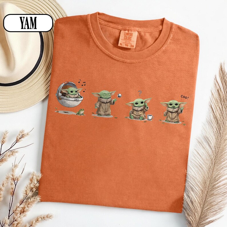 May include: Orange Comfort Colors t-shirt featuring a graphic of a character from a popular science fiction series. The graphic shows the character in four different poses. The shirt has a crew neck and short sleeves. The tag on the shirt reads XL-TG.