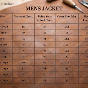 May include: A brown leather table displays a size chart for a men's jacket. The chart includes measurements for garment chest, actual chest, cross shoulder, and sleeve length in inches, ranging from 2X-Small to 5X-Large.