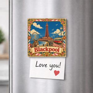 May include: A square decorative magnet featuring a colourful illustration of the Blackpool Tower, a Ferris wheel, a tram, and a donkey. The word Blackpool is printed in red on a banner. A white note with the text Love you! and a red heart is attached.