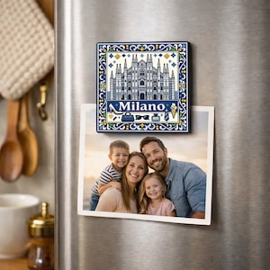 Puede incluir: Un imán de nevera con una ilustración azul y blanca de la Catedral de Milán, con la palabra "Milano" e iconos. Debajo, se muestra una foto familiar.