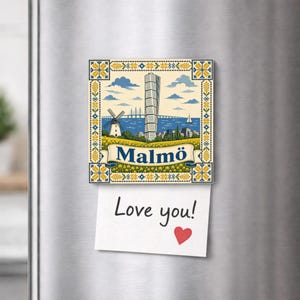 May include: A square refrigerator magnet featuring a colourful illustration of the Malmö skyline, including the Turning Torso building, a windmill, and a bridge. A white paper note with the handwritten text Love you! and a red heart is attached.