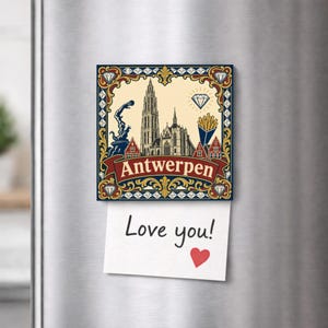 May include: A square decorative magnet featuring an illustration of the Antwerp Cathedral, a hand, a diamond, and a container of fries, with the text Antwerpen on a red banner. A white paper note with the handwritten text Love you! and a red heart.
