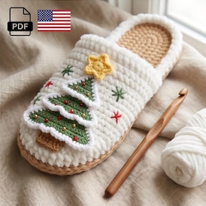 May include: A handmade white crochet slipper with a Christmas tree design. The tree is green with red and gold accents, topped with a yellow star. A wooden crochet hook and a ball of white yarn are next to the slipper. The image includes a PDF icon and an American flag.