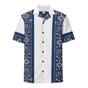 May include: White short-sleeved shirt with a button-down front and a classic collar. The shirt features a vertical white stripe down the centre, flanked by blue patterned panels with geometric designs. The sleeves and collar have blue accents.