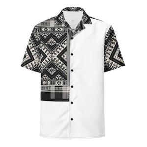 May include: Short-sleeved button-down shirt. One side is plain white, the other has a black and cream geometric pattern. The shirt has a classic collar and black buttons. The design is eye-catching and bold.