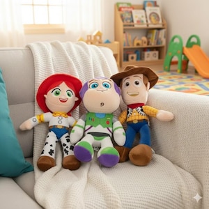 May include: Three plush toy figures of characters from the animated film Toy Story. Jessie, with red hair and a cowgirl outfit, Buzz Lightyear in a green and white spacesuit, and Woody in a cowboy outfit, are seated on a white couch.
