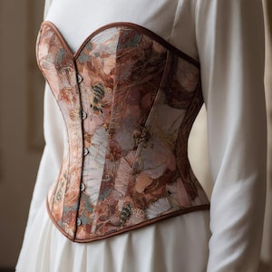 May include: A set of three ceramic mugs with a speckled, matte finish. The mugs are in shades of cream, light gray, and dark gray. Each mug has a simple, minimalist design, perfect for coffee or tea.
