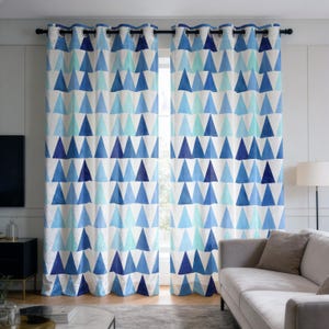 May include: A pair of floor-length curtains featuring a repeating geometric pattern of triangles in various shades of blue, light blue, and white. The curtains are suspended from a black rod using silver-toned metal grommets at the top edge.