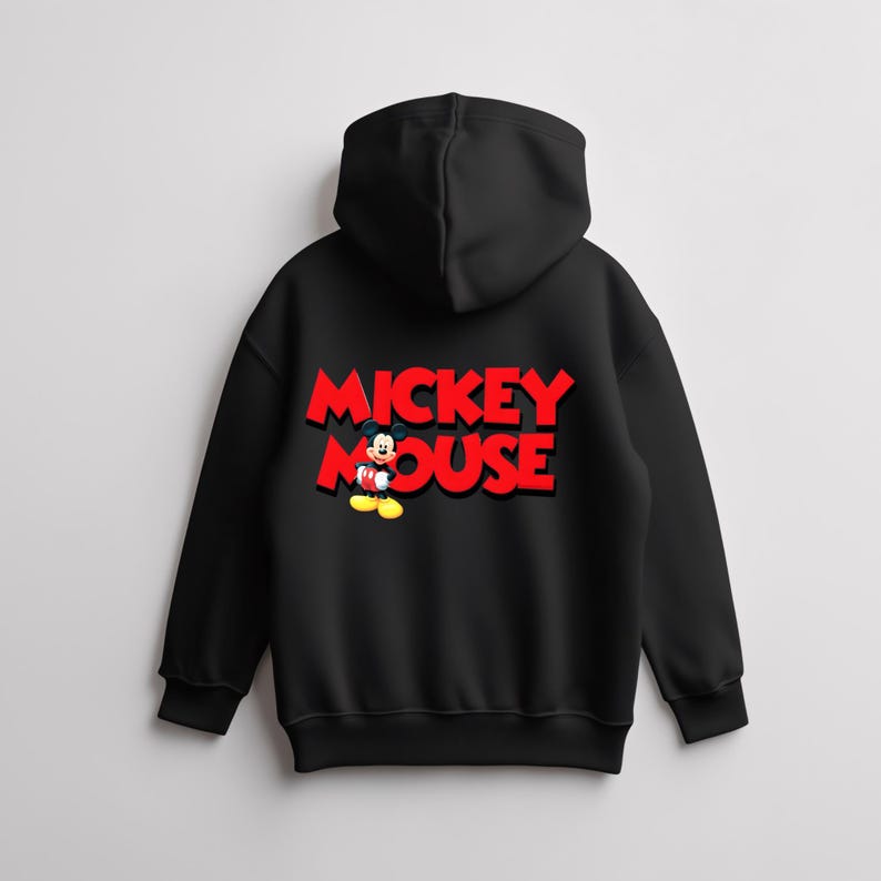 May include: Black hooded sweatshirt featuring the words "MICKEY MOUSE" in red, 3D-style lettering. A cartoon image of Mickey Mouse is positioned below the text. The sweatshirt has a drawstring hood and ribbed cuffs.