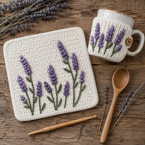 May include: A square white crochet coaster and a matching mug cozy, both featuring embroidered purple lavender sprigs with green stems. A wooden spoon and a bamboo crochet hook are placed nearby, accompanied by dried lavender sprigs.