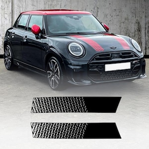 Peut inclure: Mini Cooper noire avec un toit et des rétroviseurs rouges. La voiture a des bandes de course rouges et noires sur le capot. Deux autocollants à carreaux noirs et blancs sont en dessous.