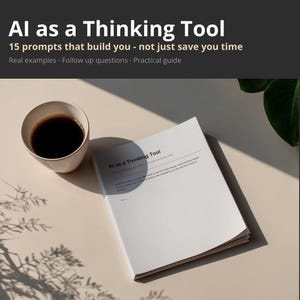 Op de afbeelding: Een open boek met de titel "AI as a Thinking Tool" met de tekst "15 prompts that build you - not just save you time." Een kopje koffie staat naast het boek. De pagina's van het boek zijn wit. De achtergrond is lichtbeige.