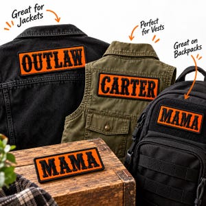 May include: Rectangular patches with black text on an orange background. One patch reads OUTLAW on a black denim jacket, one reads CARTER on an olive vest, and two read MAMA, one on a black backpack and one on a wooden surface.