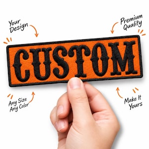 May include: A rectangular embroidered patch with an orange background and a black border. The word CUSTOM is stitched in large black serif letters across the center. Surrounding text includes Your Design, Premium Quality, Any Size Any Color, and Make It Yours.